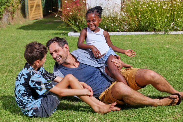 istock Father with children (6-7, 8-9) playing on back yard 2168836136