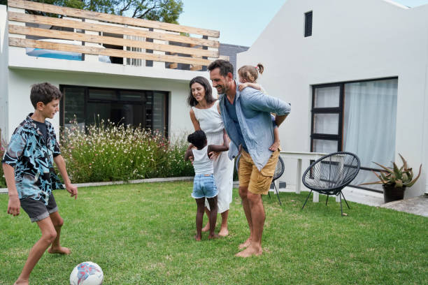 istock Parents with children (18-22 months, 6-7, 8-9) playing on back yard 2168836137