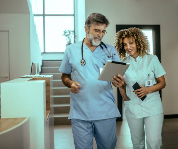 istock Confident doctor using mobile phone and digital tablet  in hospital 2168836169
