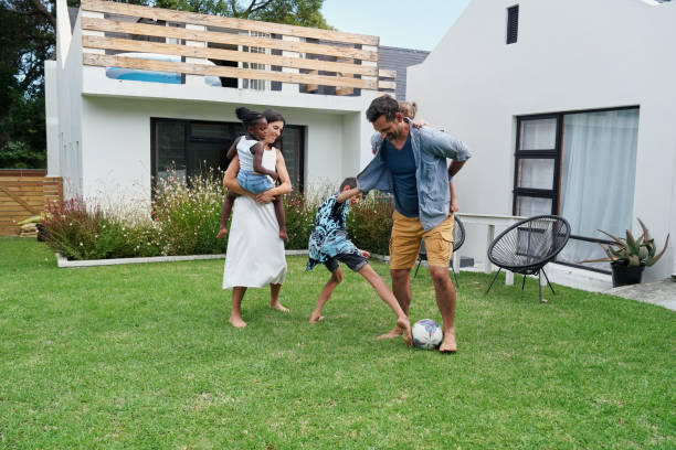 istock Parents with children (18-22 months, 6-7, 8-9) playing on back yard 2168837195