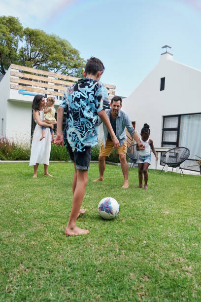 istock Parents with children (18-22 months, 6-7, 8-9) playing on back yard 2168837435