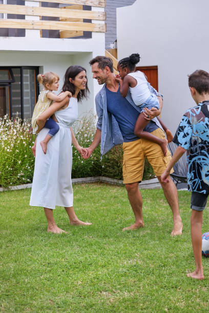 istock Parents with children (18-22 months, 6-7, 8-9) playing on back yard 2168837988