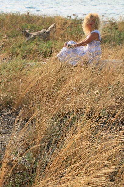 Relaxing In Grass By The Sea