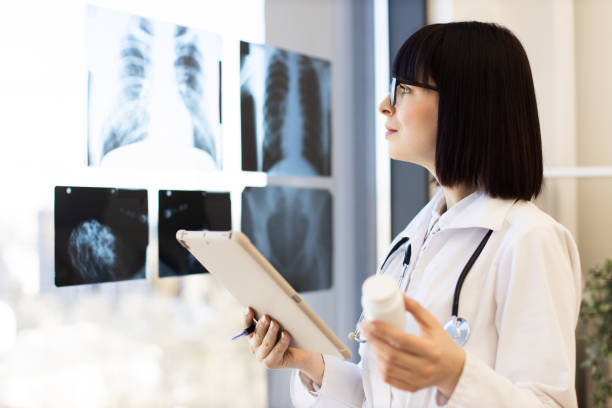 istock Female doctor examining x-rays with tablet and medication 2168839533