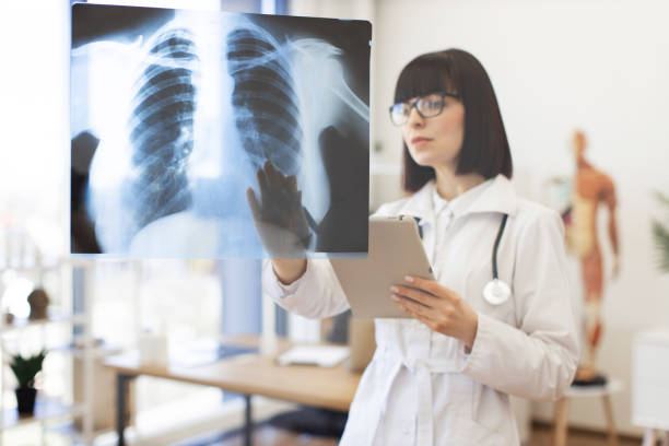 istock Female doctor examining x-rays on glass board in office 2168839558