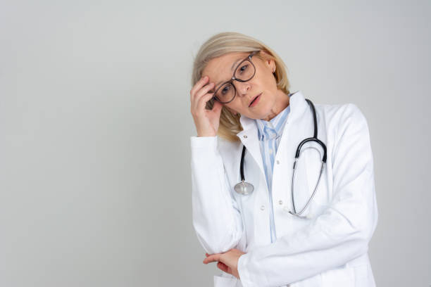 istock Stressed tired healthcare worker standing isolated 2168840032