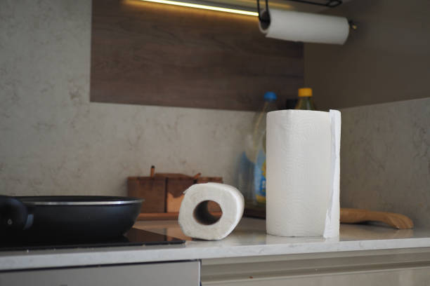 A modern kitchen design with essential paper towels and organized cooking tools on the countertop