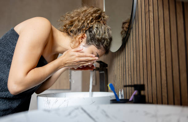 istock Woman at home washing her face 2168843622
