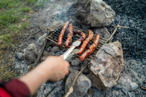 Young girl preparing food on grill