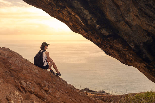 istock Woman watching beautiful sunrise from mountain top. 2168846299