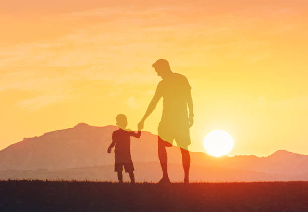 istock Father and son spending time together at sunset. 2168846374