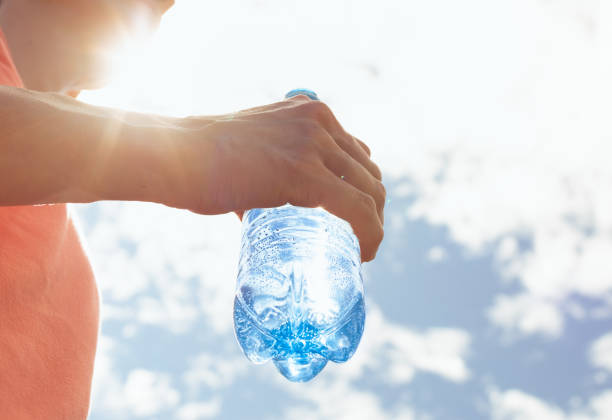 istock Person drinking water on a hot day. 2168846519