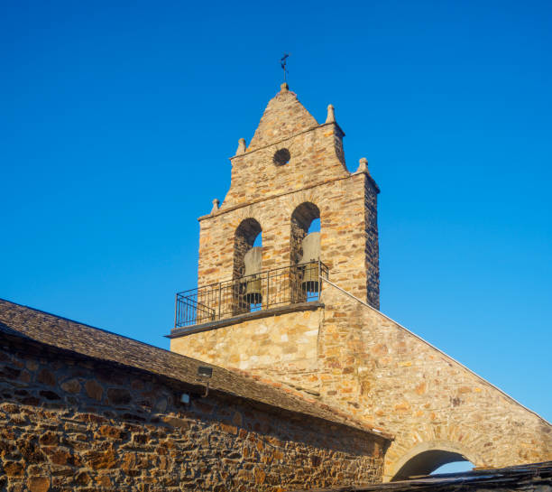 istock Bell tower with a stork nests on top against clear blue sky. 2168850359