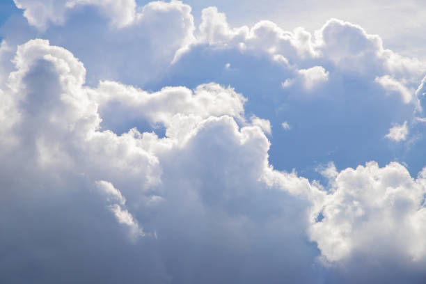 huge fluffy white cloud and sun rays on a sunny day. Divine heavens