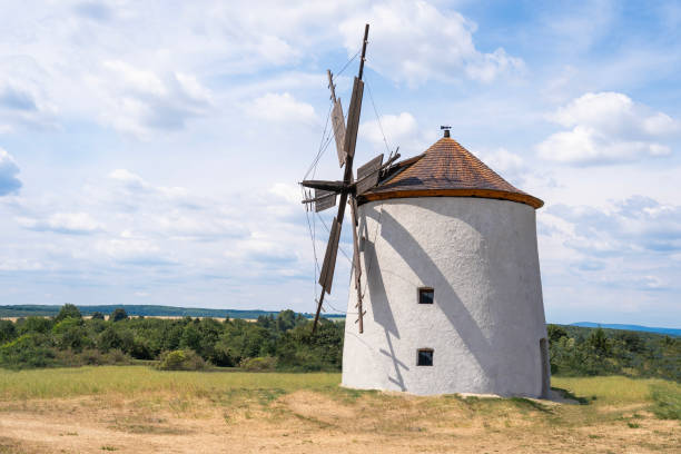Traditional old windmill with cloudy blue sky in the background