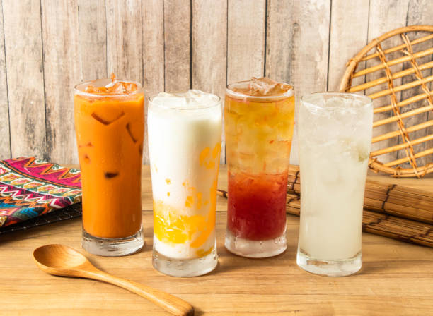istock Assorted Thai Iced Drinks Ice Thai Milk Tea, Creamy Mango Milk iced Tea, Spring Bud Grapefruit iced tea, Refreshing Ice Lemonade served in tall glasses with ice cubes side view of taiwan drink 2168854050