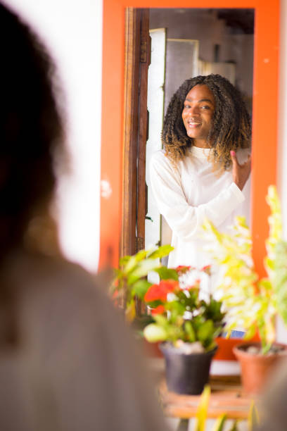 istock fixing your hair before going out 2168854240