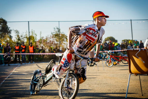 Male athlete jumping high on bmx bike against a cloudy sky