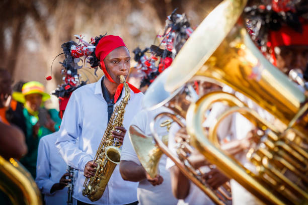 Girl seen in the Brass band dressed in recycled headwear and playing her saxophone along the route.  A parade and various art performances were held to promote and celebrate recycling towards saving the environment for future generations.
