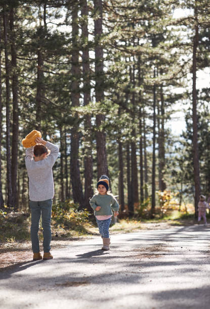 istock Happy children enjoying autumn in forest 2168856399