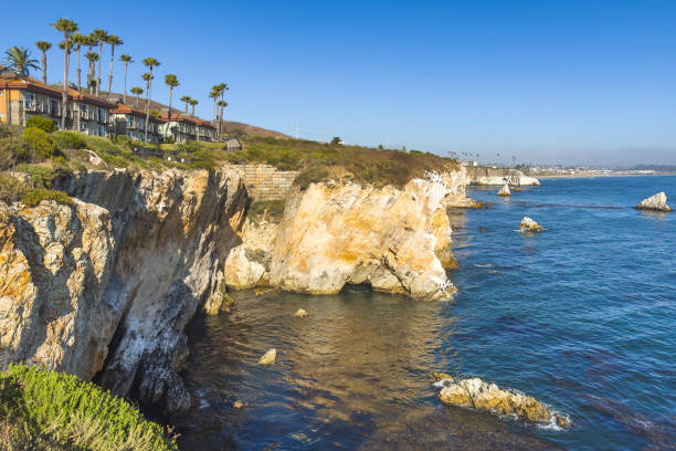 istock Cliffside homes overlooking a rugged coastline with clear blue waters. 2168857230