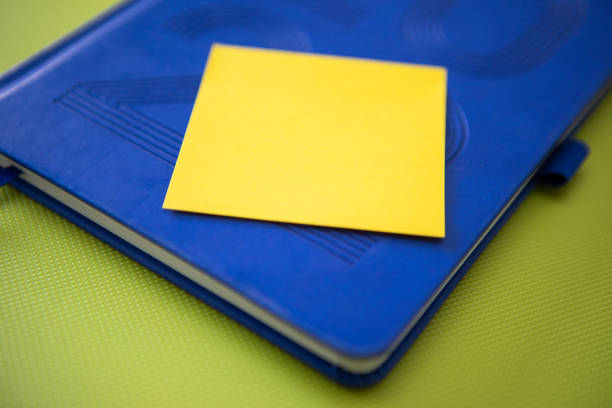 Yellow coloured adhesive note left blank for your own message