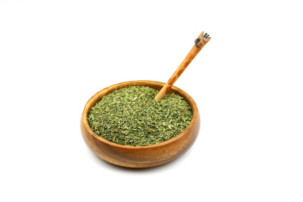 istock Dry mint in wooden bowl isolated on white background 2168861869
