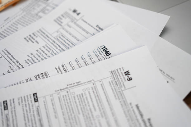 istock Tabletop cluttered with diverse tax forms signifying annual tax preparation ritual 2168864511