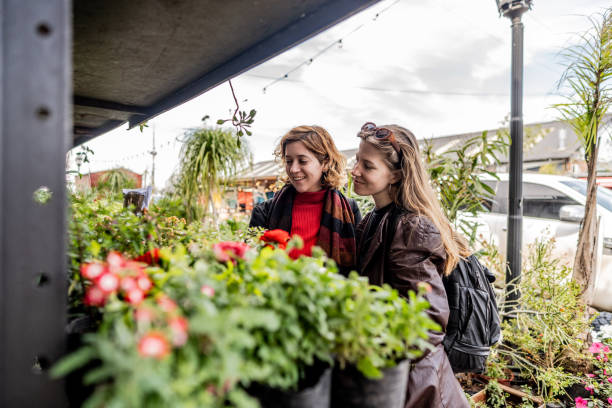 istock Lesbian choosing plants on street market 2168865005