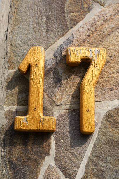 istock Yellow number seventeen on a stone wall 2168865361