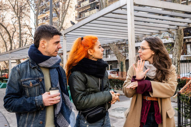 istock Deaf friends speaking in sign language outdoors 2168867671