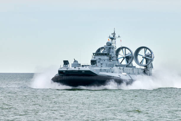istock Hovercraft warship armed with armament sails into sea toward military target to attack and destroy 2168868081