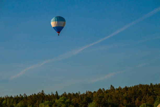 Gothenburg, Sweden - May 12 2024: Blue white and red hot air balloon in evening sun.