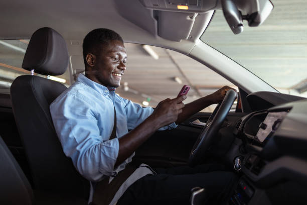 istock Man texting in his car with a smile 2168873132