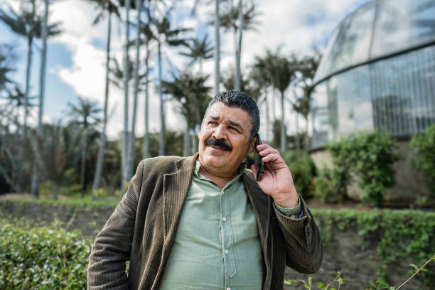 Senior man talking on mobile phone on a public park