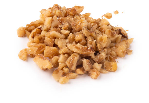 istock pile of chopped walnuts isolated for topping ingredient 2168876671