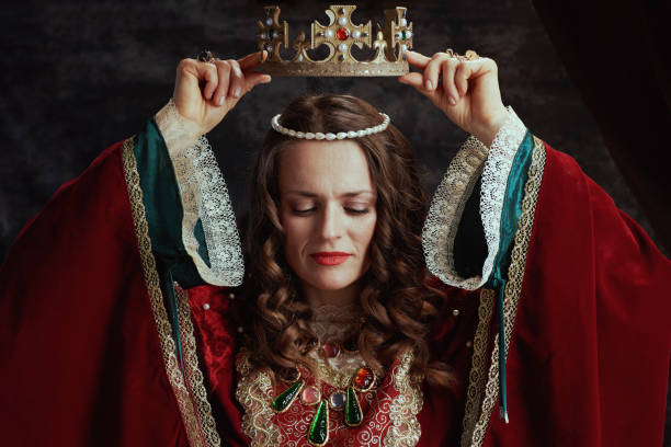 istock medieval queen in red dress with crown 2168878241