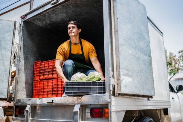 Mid adult man unloading truck inside truck