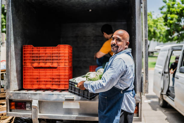 istock Senior man unloading truck to store 2168879699