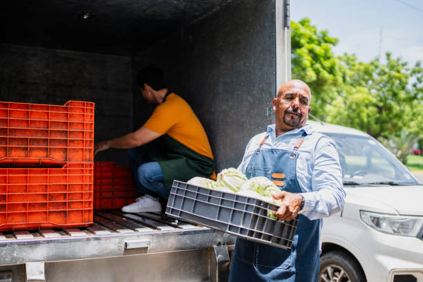 istock Senior man unloading truck to store 2168879701