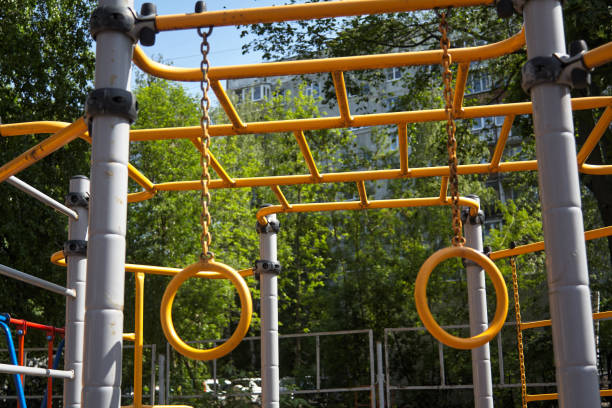 istock child hanging from a playground structure yellow metal 2168880072