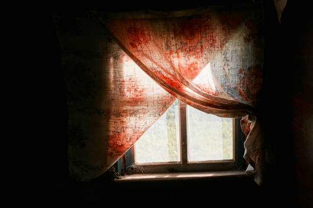 istock An aged rustic window, curtains and a dark room 2168880075