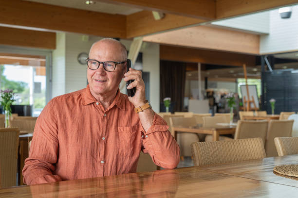 istock Senior Finnish Man Using Mobile Phone in Restaurant during Autumn 2168883921