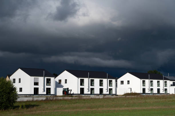 istock houses and dark clouds 2168885195