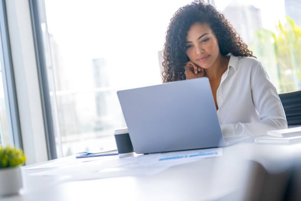 istock Happy Young woman working on a laptop computer in the office 2168886888