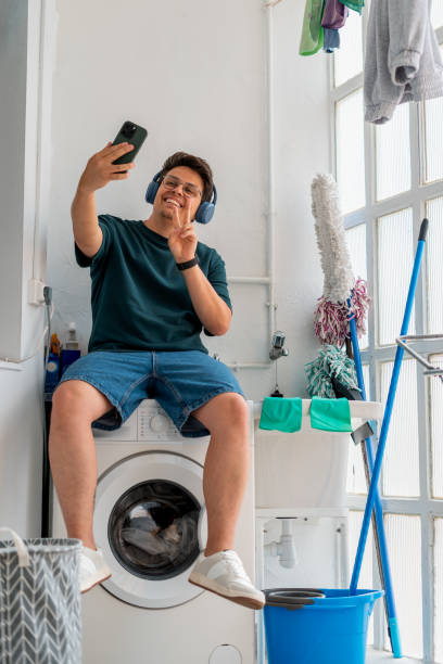 istock Man taking a selfie while waiting for laundry to finish 2168891131