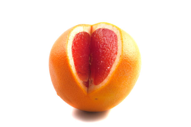 A large grapefruit with a cut-out part on a white background. Side view. Isolated.