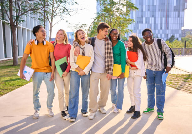 istock Group generation z international university students laughing standing hugging together on campus. 2168896555