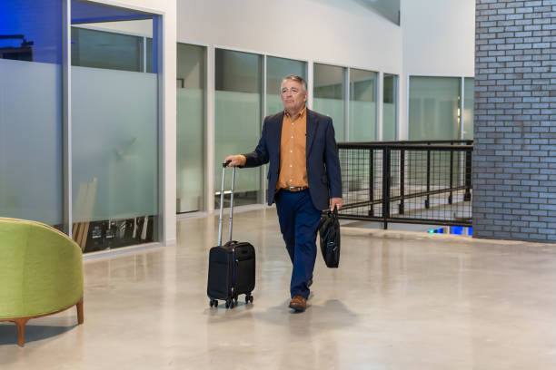 istock Business man walking through airport terminal with backpack 2168898958