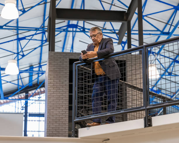 istock Business man on phone in modern office building 2168899255